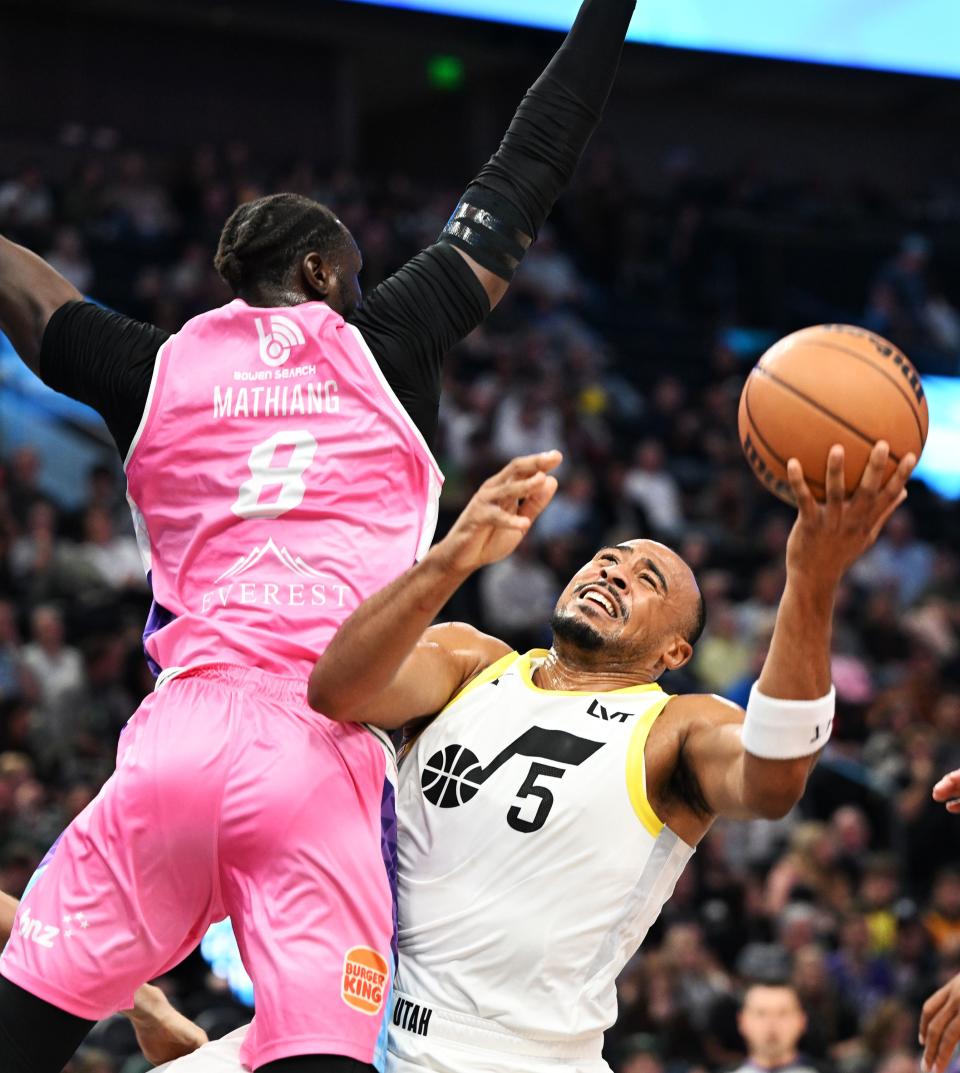 Utah Jazz guard Talen Horton-Tucker (5) is hit by New Zealand Breakers center Mangok Mathiang (8) as he tries to push up a shot as the Jazz and the Breakers play at the Delta Center in Salt Lake City on Monday, Oct. 16, 2023. | Scott G Winterton, Deseret News