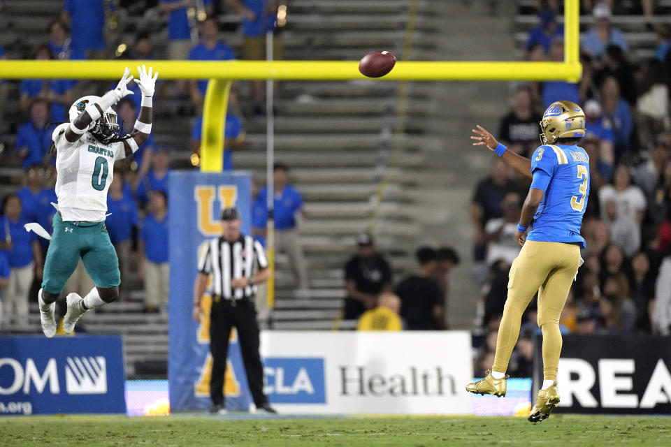 Coastal Carolina cornerback Juan Powell, left, blocks the pass of UCLA quarterback Dante Moore during the first half of an NCAA college football game Saturday, Sept. 2, 2023, in Pasadena, Calif. (AP Photo/Mark J. Terrill)