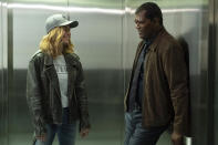 This image released by Disney-Marvel shows Samuel L. Jackson, right, with Brie Larson on the set of "Captain Marvel." New digital de-aging techniques have shaved decades from Jackson's face. The young Nick Fury was created by comparing footage from old Jackson movies with the work the actor did on set — again, using tracking markers. (Chuck Zlotnick/Disney/Marvel Studios via AP)