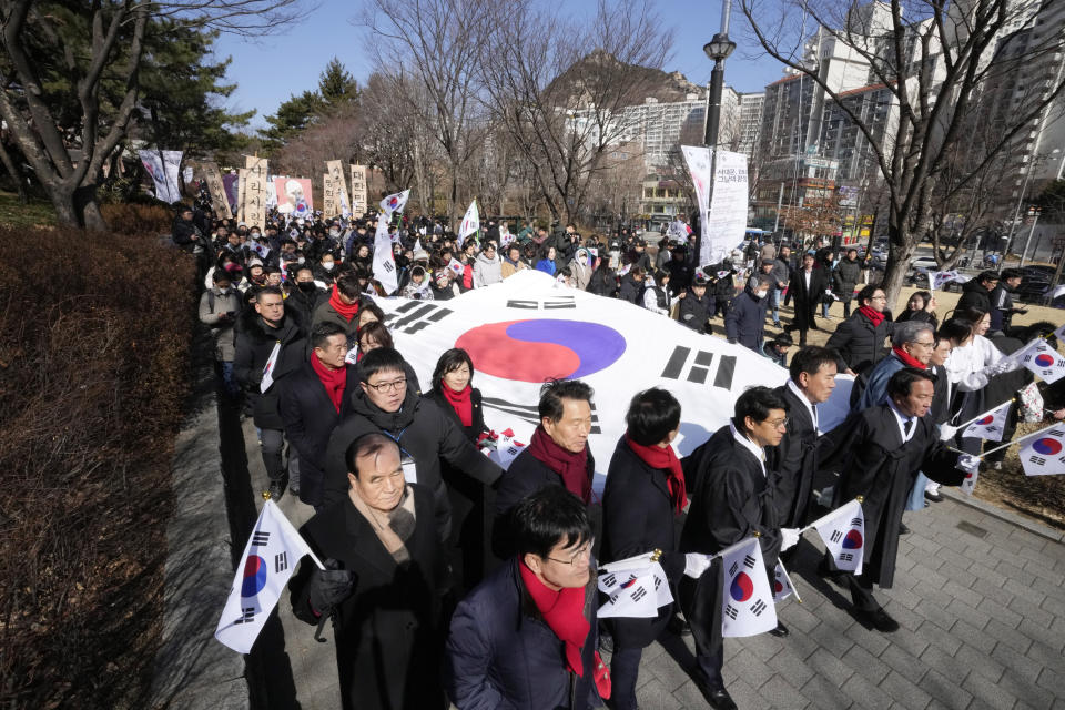 South Koreans march during a ceremony to celebrate the March First Independence Movement Day, the anniversary of the 1919 uprising against Japanese colonial rule, in Seoul, South Korea, Friday, March 1, 2024. (AP Photo/Ahn Young-joon)