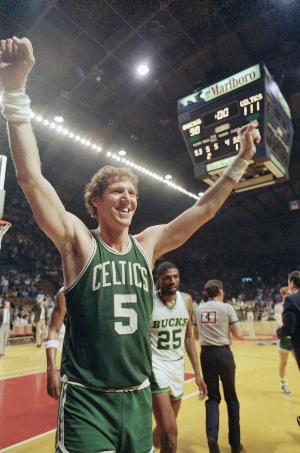 Bostons Bill Walton (5) heads off the court with his arms raised following the Celtics 111-98 victory over Milwaukee for the National Basketball Association Eastern Conference title, Sunday, May 18, 1986, Milwaukee, Wisc. In the background is the Bucks Paul Pressey. (AP Photo/Steve Pyle)