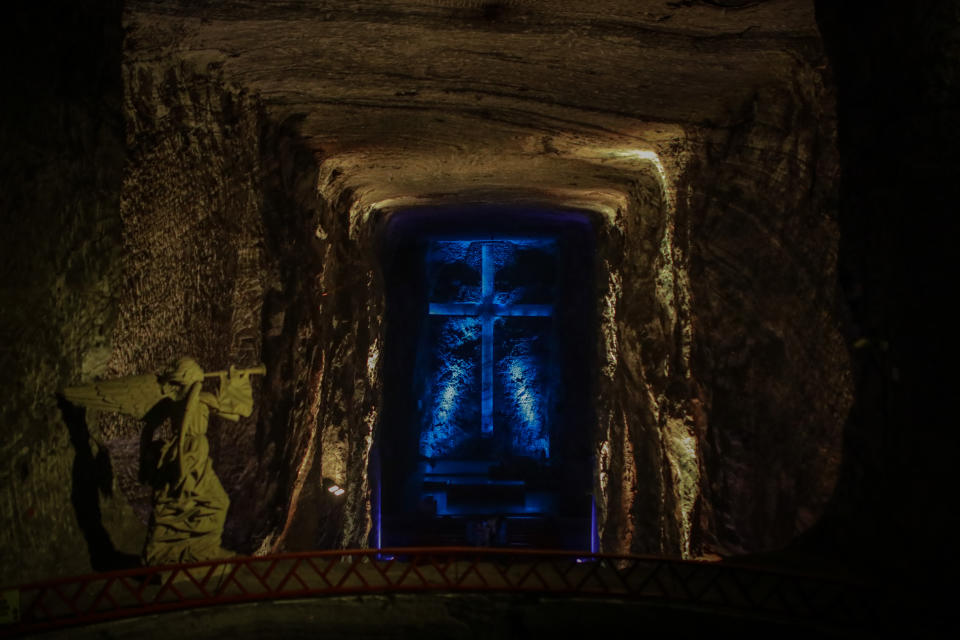 ZIPAQUIRA, COLOMBIA - SEPTEMBER 29: A group of foreign tourists and locals visit The Salt Cathedral of Zipaquira, inside a salt mine that has been exploited since 1801, in Zipaquira, Colombia on September 29, 2022. An underground Roman Catholic church built within the tunnels of a salt mine 200 meters (660 ft) underground in a halite mountain near the city of Zipaquira, in Cundinamarca, Colombia. It is a tourist destination and place of pilgrimage in the country. The temple at the bottom has three sections, representing the birth, life, and death of Jesus. The icons, ornaments, and architectural details are hand carved in the halite rock. Some marble sculptures are included. The cathedral is considered one of the most notable achievements of Colombian architecture, being described as a 