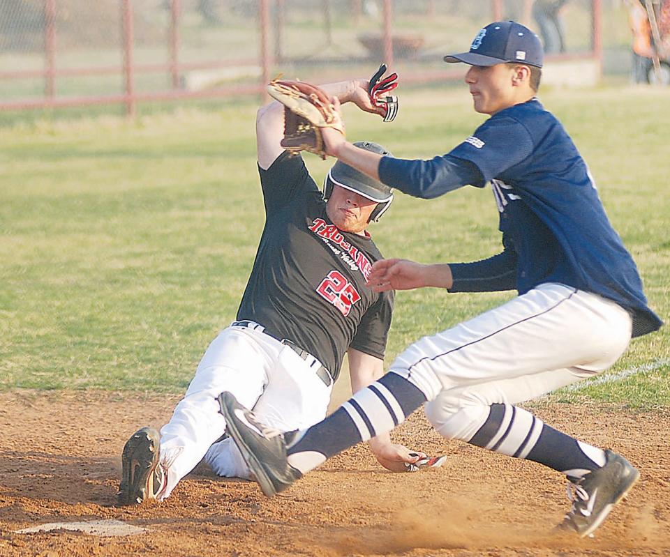 Also during his prep days at Bartlesville High, A.J. Archambo, right, waits on a throw while Caney Valley High's Tristen Gagan slides toward the dish. Gagan also starred in college ball. His younger brother Troy currently is the leading hitter for Missouri Southern State.