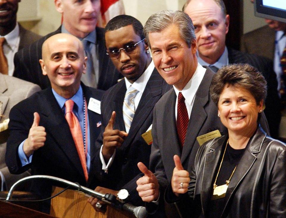 Diddy range the NYSE bell with former chairman Richard Grasso (left), former president of Federated Department Stores Terry Lundgren (right of Diddy), and chairman and CEO of Federated Merchandising Group Janet Grove (right). AFP via Getty Images