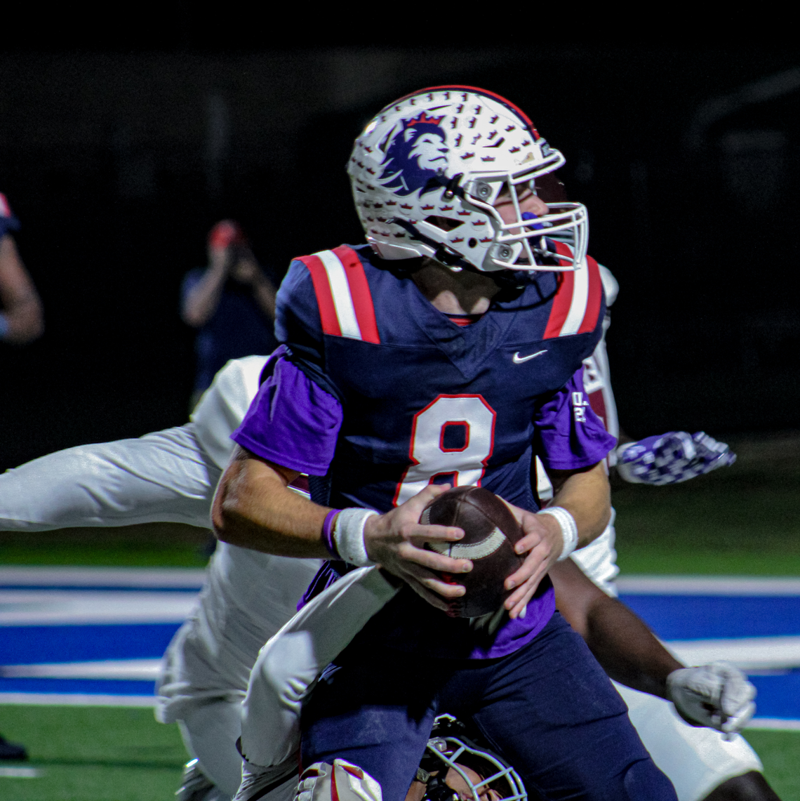 Richland quarterback Drew Kates looks downfield to pass while being pressured by Mansfield Timberview defenders on Friday, October 27, 2023 at Birdville Fine Arts/Athletics Complex in North Richland Hills, Texas.