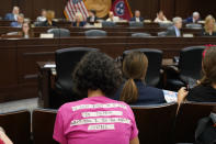 CORRECTS DAY TO WEDNESDAY - Leila Abolfazli wears a shirt with a taped message in the House Insurance Committee meeting during a special session of the state legislature on public safety Wednesday, Aug. 23, 2023, in Nashville, Tenn. (AP Photo/George Walker IV)