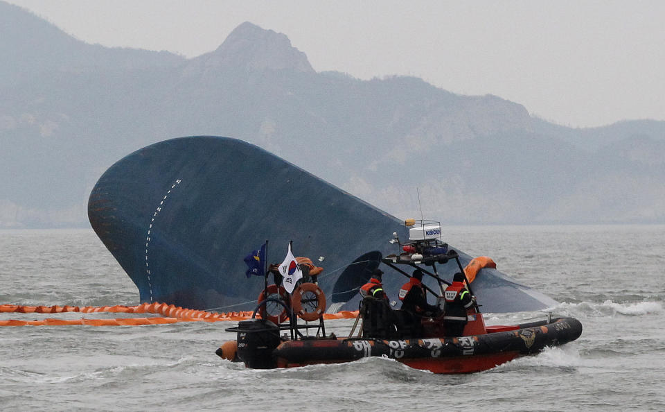 South Korean Coast Guard officers search for missing passengers from a sunken ferry in the water off the southern coast near Jindo, South Korea, Thursday, April 17, 2014. Strong currents, rain and bad visibility hampered an increasingly anxious search Thursday for more than 280 passengers still missing a day after their ferry flipped onto its side and sank in cold waters off the southern coast of South Korea.(AP Photo/Ahn Young-joon)