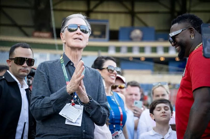 Boston Red Sox Principal Owner John Henry talks with Former Boston Red Sox designated hitter David Ortiz before the 2024 Dominican Republic Series game against the Tampa Bay Rays as part of the MLB World Tour at Estadio Quisqueya on March 9, 2024 in Santo Domingo, Dominican Republic.