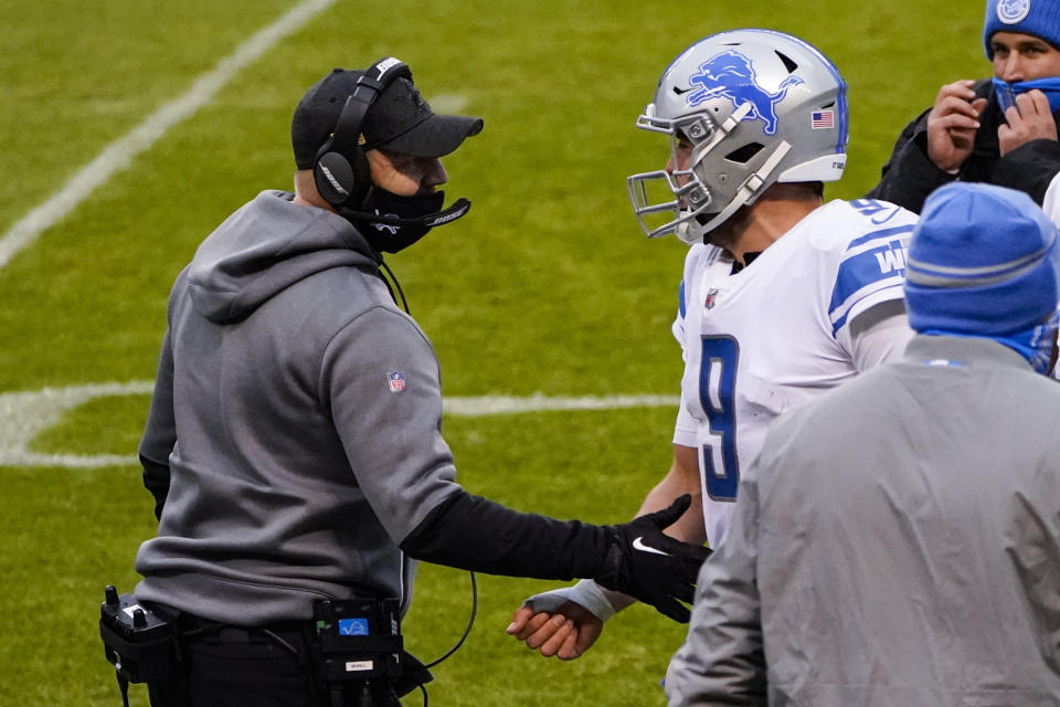 Detroit Lions head coach Darrell Bevell talks with quarterback Matthew Stafford (9) after he threw a touchdown pass against the Chicago Bears in the second half of an NFL football game in Chicago, Sunday, Dec. 6, 2020. (AP Photo/Charles Rex Arbogast)