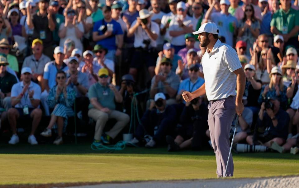 Scottie Scheffler celebrates a birdie on the last