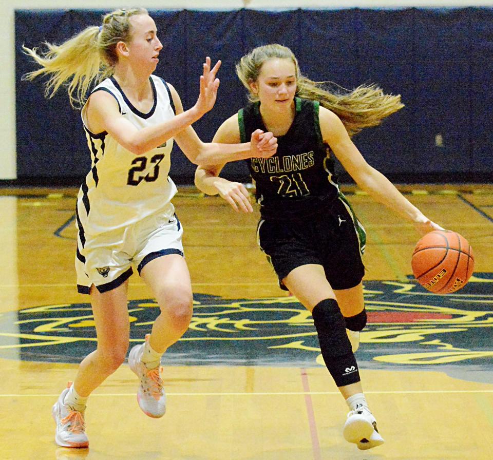 Clark-Willow Lake's Alicia Vig (right) advances the ball against Great Plains Lutheran's Bryn Holmen during their high school girls basketball game Monday night in Watertown. Clark-Willow Lake won 45-36.