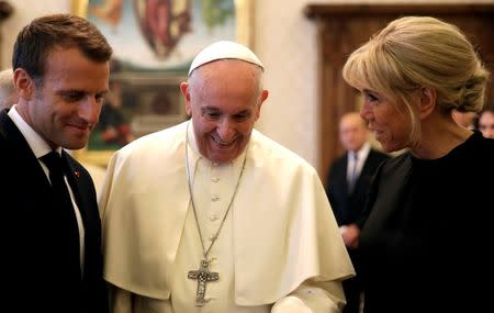 Pope Francis shares a word with French President Emmanuel Macron and his wife Brigitte during a private audience at the Vatican, June 26, 2018. Alessandra Tarantino/Pool via Reuters