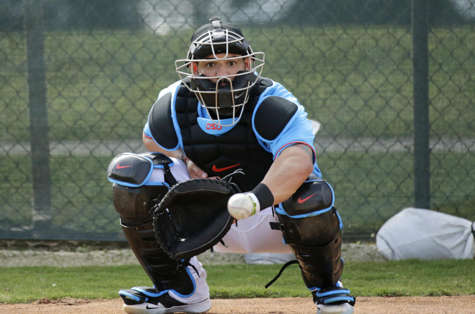 FILE - In this Feb. 12, 2020, file photo, Miami Marlins catcher Jorge Alfaro eyes the baseball during a spring training baseball workouts for pitchers and catchers at Roger Dean Stadium in Jupiter, Fla. Francisco Cervelli says he’s fully recovered from his latest concussion, and Jorge Alfaro says he’s feeling fitter after an offseason spent working on the farm and running sprints. At catcher, at least, the Miami Marlins appear in good shape. (David Santiago/Miami Herald via AP, File)