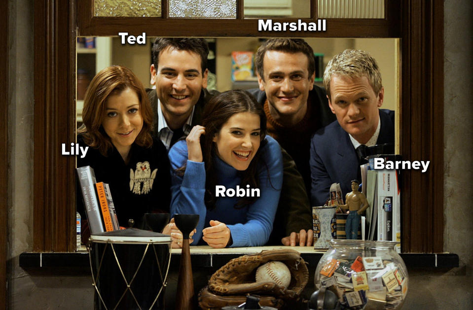 The cast of HIMYM poses for a promotional shot through a window