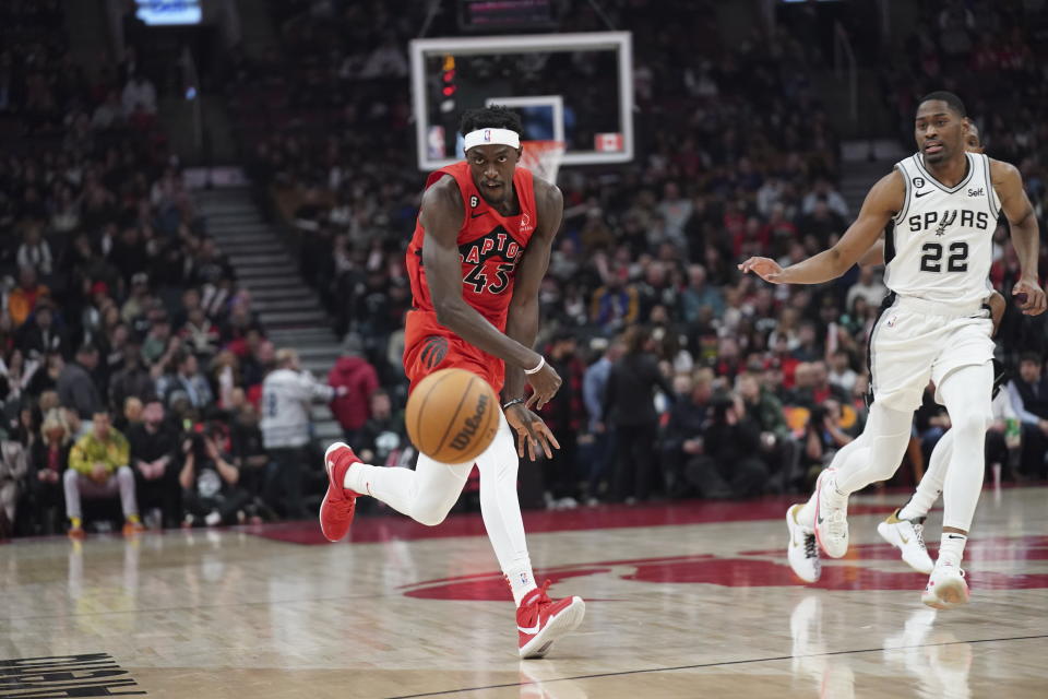 Toronto Raptors forward Pascal Siakam (43) passes the ball as San Antonio Spurs guard Malaki Branham (22) defends during the first half of an NBA basketball game Wednesday, Feb. 8, 2023, in Toronto. (Arlyn McAdorey/The Canadian Press via AP)