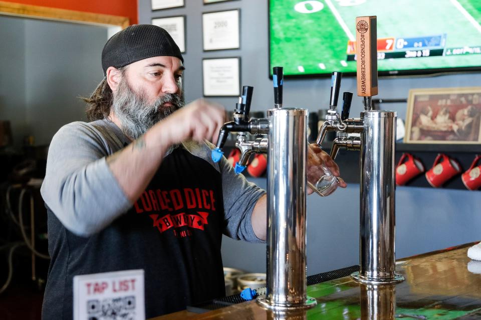 Jef Smith pours a beer at the Loaded Dice Brewery in Troy on Sunday, Oct. 17, 2021.