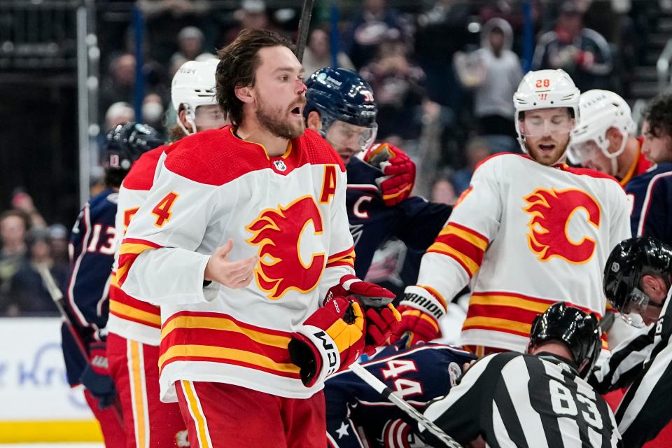 Oct 20, 2023; Columbus, Ohio, USA; Calgary Flames defenseman Rasmus Andersson (4) skates off the ice with a bloodied nose after being pummeled by Columbus Blue Jackets defenseman Erik Gudbranson (44) following his hit to Columbus Blue Jackets right wing Patrik Laine during the third period of the NHL hockey game at Nationwide Arena. The Blue Jackets on 3-1.