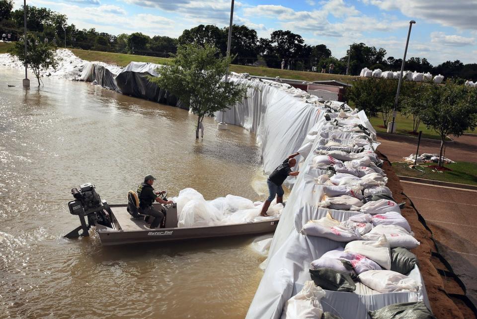 A crew inspects a levee constructed around a medical center to hold back floodwater from the Mississippi River in Vidalia, La., in 2011. <a href="https://www.gettyimages.com/detail/news-photo/dennis-barkemeyer-inspects-a-levee-constructed-around-a-news-photo/114243924" rel="nofollow noopener" target="_blank" data-ylk="slk:Scott Olson/Getty Images;elm:context_link;itc:0;sec:content-canvas" class="link ">Scott Olson/Getty Images</a>