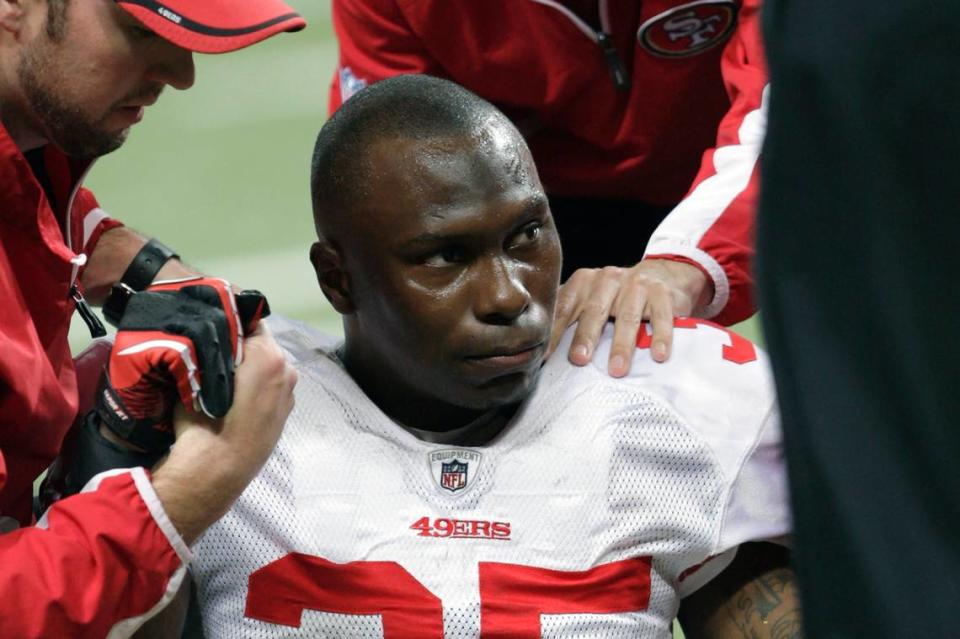 FILE - In this Dec. 26, 2010 file photo, San Francisco 49ers cornerback Phillip Adams (35) is attended to after injuring his left leg during the third quarter of an NFL football game against the St. Louis Rams, in St. Louis. A source briefed on a mass killing in South Carolina says the gunman who killed multiple people, including a prominent doctor, was the former NFL pro. The source said that Adams shot himself to death early Thursday, April 8, 2021.