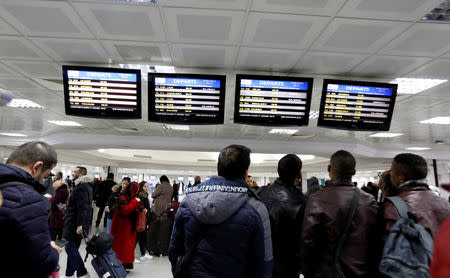 Passengers look at information boards at the Tunis airport during a nationwide strike in Tunis, Tunisia January 17, 2019. REUTERS/Zoubeir Souissi