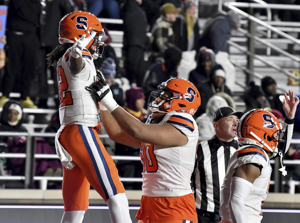 Syracuse's wide receiver Damien Alford and Matthew Bergeron (60) celbrate Alford's go-ahead touchdown during the second half of an NCAA college football game against Boston College, Saturday, Nov. 26, 2022, in Boston. (AP Photo/Mark Stockwell)