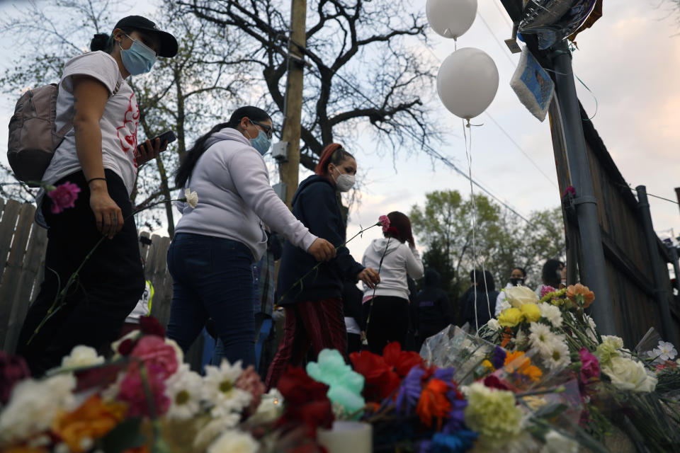 People pay tribute as they attend a peace walk honoring the life of police shooting victim 13-year-old Adam Toledo, Sunday, April 18, 2021, in Chicago's Little Village neighborhood. (AP Photo/Shafkat Anowar)