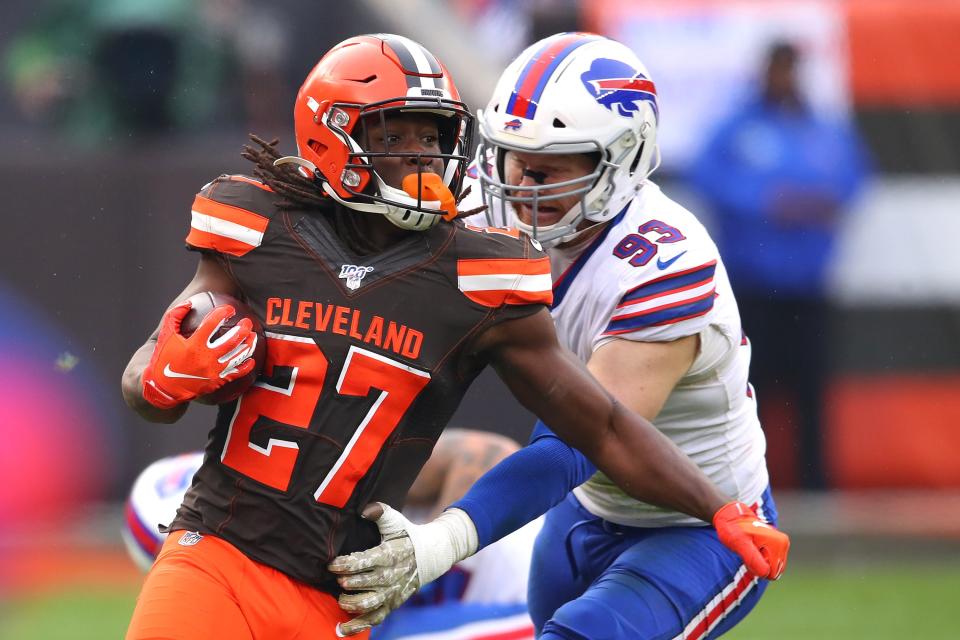 Kareem Hunt of the Browns tries to escape a tackle by ex-Bill Trent Murphy in 2019.