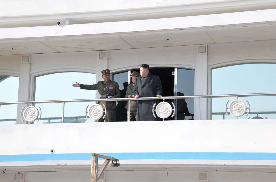 This picture released by North Korea's official Korean Central News Agency on March 26, 2013 and taken on March 25, 2013 shows North Korean leader Kim Jong-Un (C) speaking with officials  during his inspection of the landing and anti-landing drills of KPA Large Combined Units 324 and 287 and KPA Navy Combined Unit 597 at an undisclosed location on North Korea's east coast.