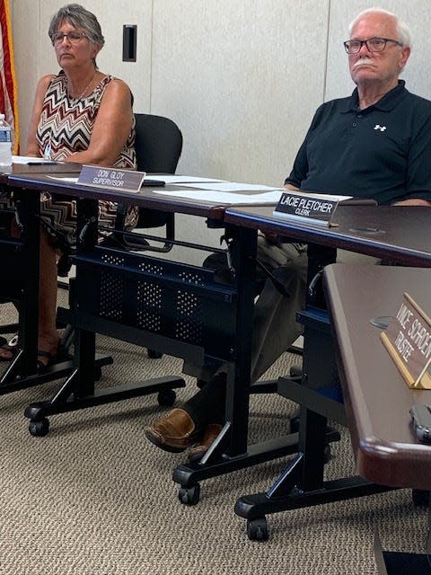 White Pigeon Township Board members Trudy and Don Gloy listen to audience comments last week during a special meeting. They are included in a recall being sought by a small group of township residents.