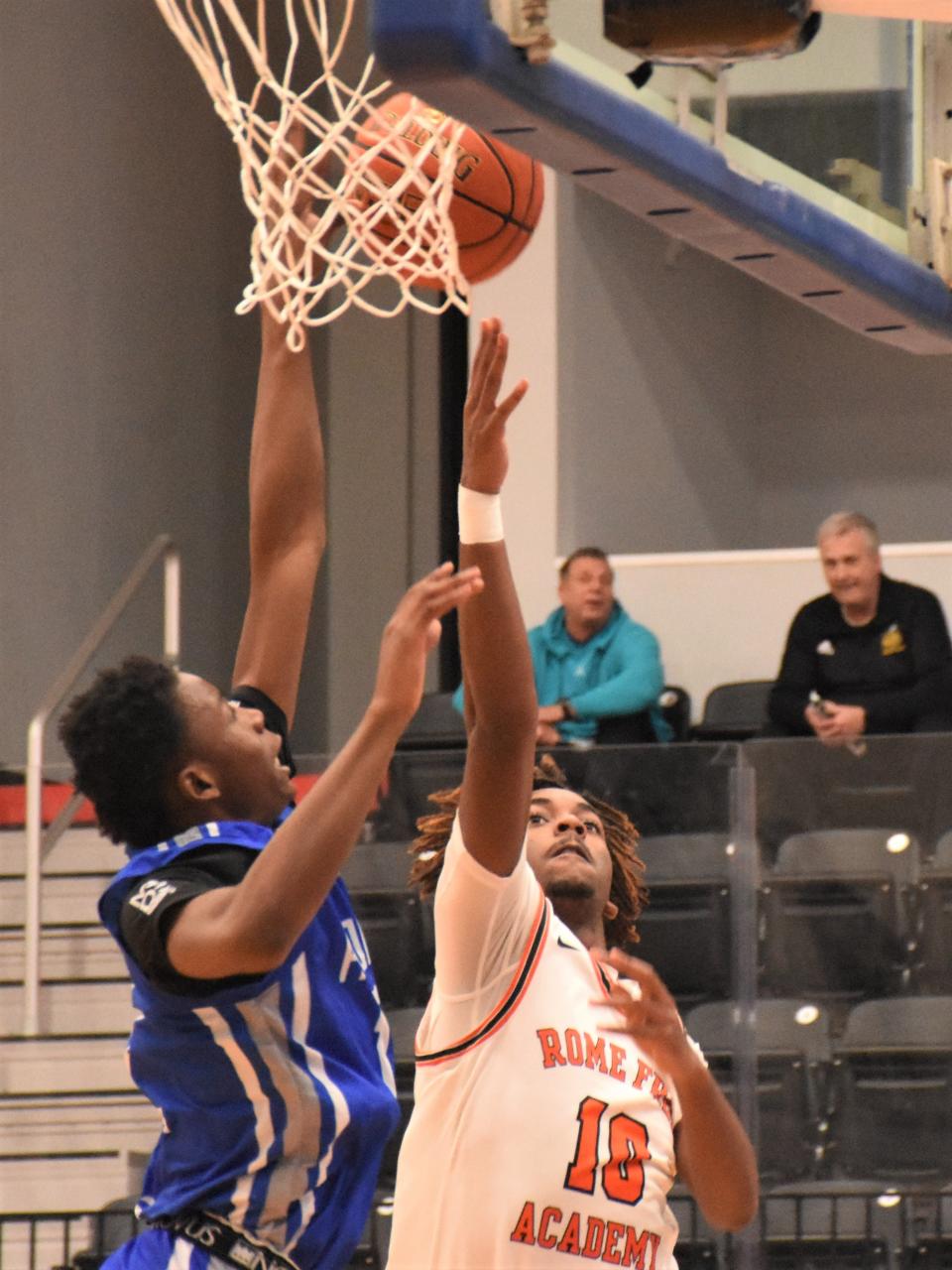 Rome Free Academy's Isaiah DeJean (10) throws up a shot over an Albany defender Thursday at the Downtown Classic in Utica.