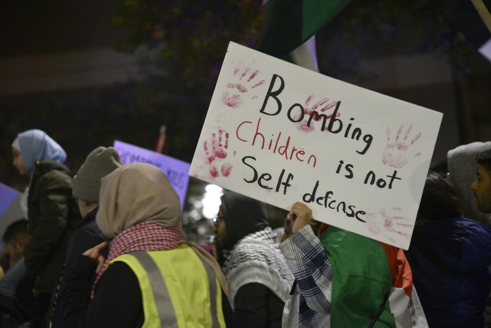 A person carried a sign at a pro-Palestinian rally on Tuesday, Oct. 17, 2023 in Windsor. 