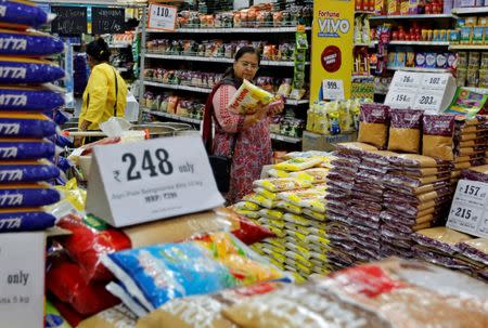 FILE PHOTO: A woman looks at an item as she shops at a food superstore in Ahmedabad, October 13, 2016. REUTERS/Amit Dave/File Photo