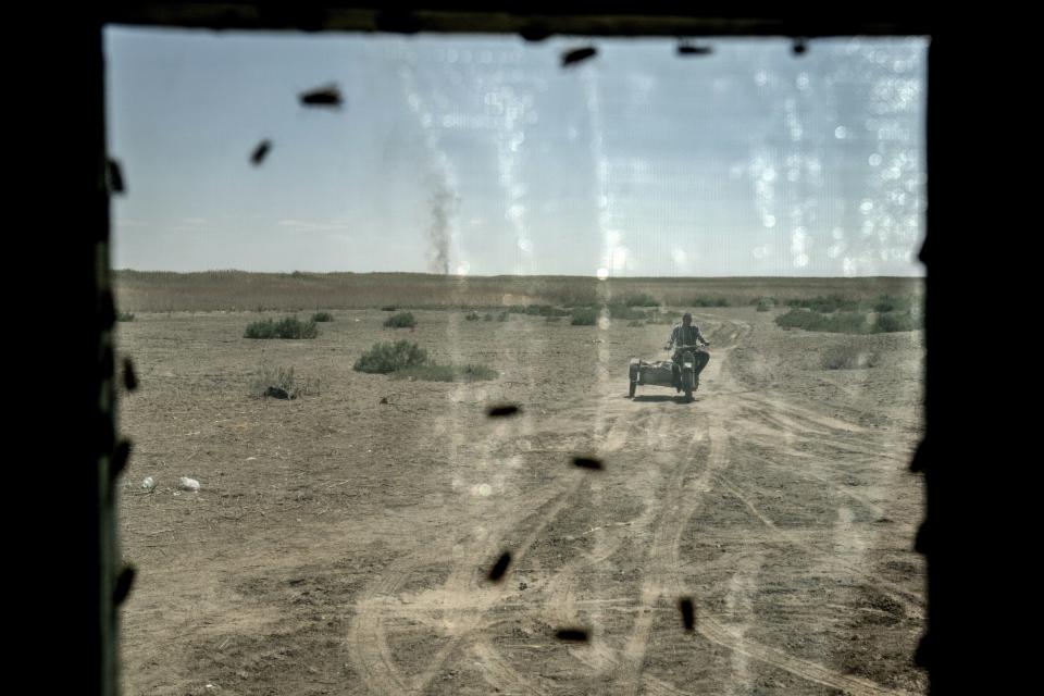 A man rides to his home through the area of the dried-up Aral Sea in Uzbekistan, Saturday, June 24, 2023. The demise of the once-mighty sea has affected thousands of residents and their livelihoods for decades. (AP Photo/Ebrahim Noroozi)