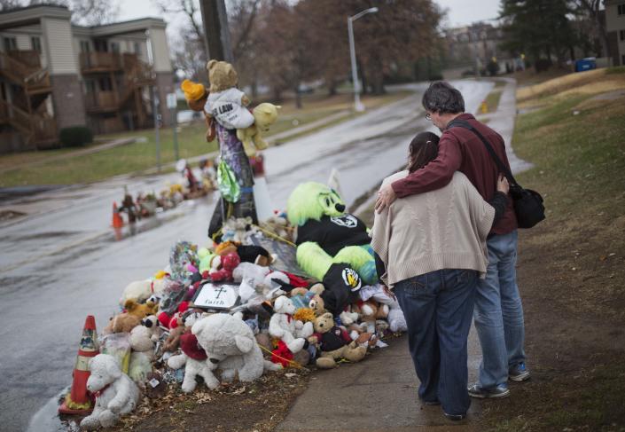 Ferguson residents Lisa Tebbe and John Powell embrace at the site where Michael Brown died. (AP Photo/David Goldman)