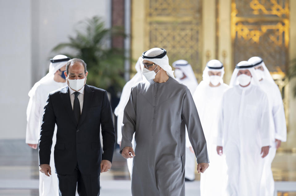 This photo provided by the Ministry of Presidential Affairs, shows Egyptian President Abdel Fattah El Sisi, left, walking with Sheikh Mohamed bin Zayed Al Nahyan, the new President of the United Arab Emirates, on his arrival to offer offers condolences on the death of Sheikh Khalifa bin Zayed Al Nahyan, the late President of the UAE, at the Presidential Airport in Abu Dhabi, UAE, Saturday, May 14, 2022. (Mohamed Al Hammadi/Ministry of Presidential Affairs via AP)