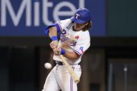 Texas Rangers' Josh Smith connects for a single to right in the second inning of a baseball game against the Tampa Bay Rays, Monday, May 30, 2022, in Arlington, Texas. The hit was on Smith's major league debut. (AP Photo/Tony Gutierrez)