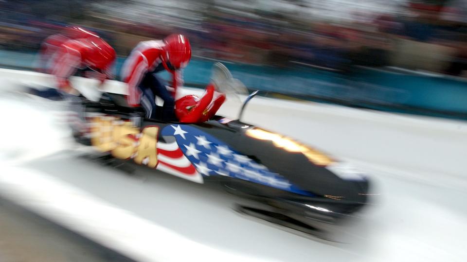 Team USA-2 jumps into their sled during their fourth and final run of the four-man bobsleigh at the Utah Olympic Park on Saturday, Feb. 23, 2002. | Jason Olson, Deseret News