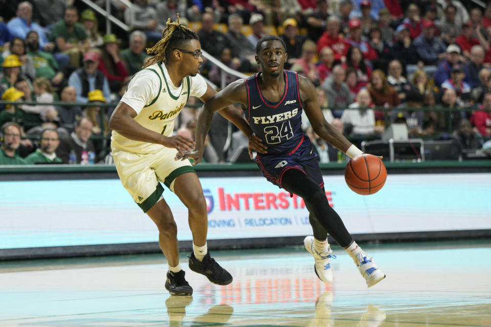 Dayton guard Kobe Elvis (24) dribbles to the basket as George Mason guard Ronald Polite III (1) defends during the first half of an NCAA college basketball game, Wednesday, Feb. 21, 2024, in Fairfax, Va. (AP Photo/Jess Rapfogel)