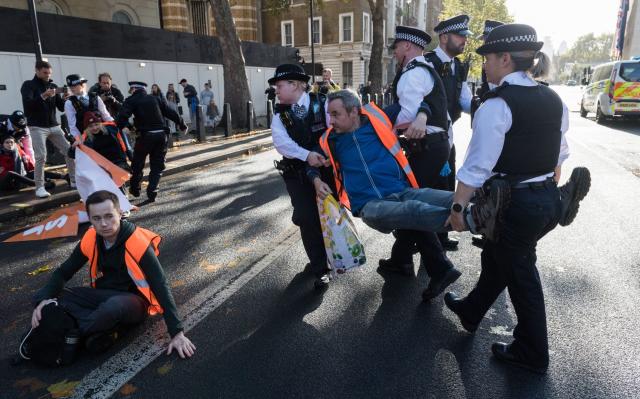 Police officers remove Just Stop Oil protesters outside Whitehall last November - GETTY IMAGES