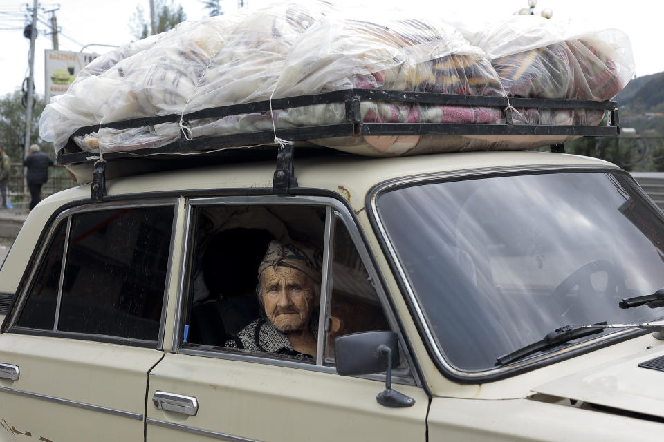 An ethnic Armenian woman from Nagorno-Karabakh sits inside an old Soviet style car as she arrives in Goris, in Armenia's Syunik region, Wednesday, Sept. 27, 2023. (AP Photo/Vasily Krestyaninov)