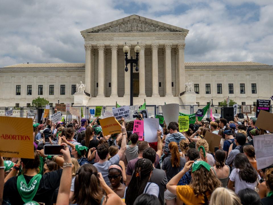 Pro-life and abortion-rights advocates crowd the Supreme Court building after Roe v. Wade was overturned Friday morning.