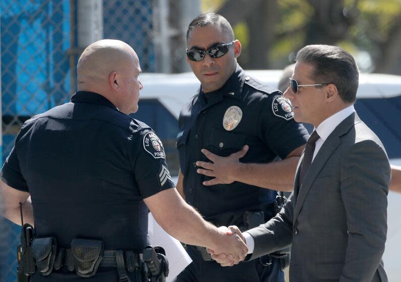 LOS ANGELES, CALIF. - MAR. 9, 2022. LAUSD Superintendent Alberto Carvalho, right, meets with school police officers before entering Crenshaw High School in Los Angeles, scene of a large brawl that involved students and their parents on Wednesday, Mar. 9, 2022. (Luis Sinco / Los Angeles Times)