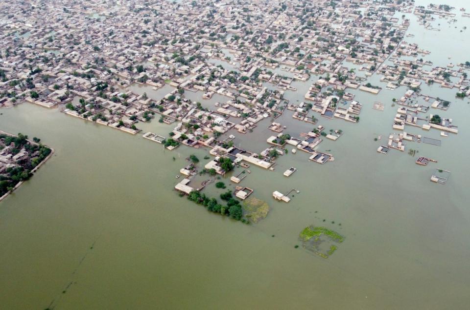 Homes surrounded by floodwaters in Jafarabad, a district of Pakistan's southwestern Baluchistan province in September following monsoon flooding (Copyright 2022 The Associated Press. All rights reserved)