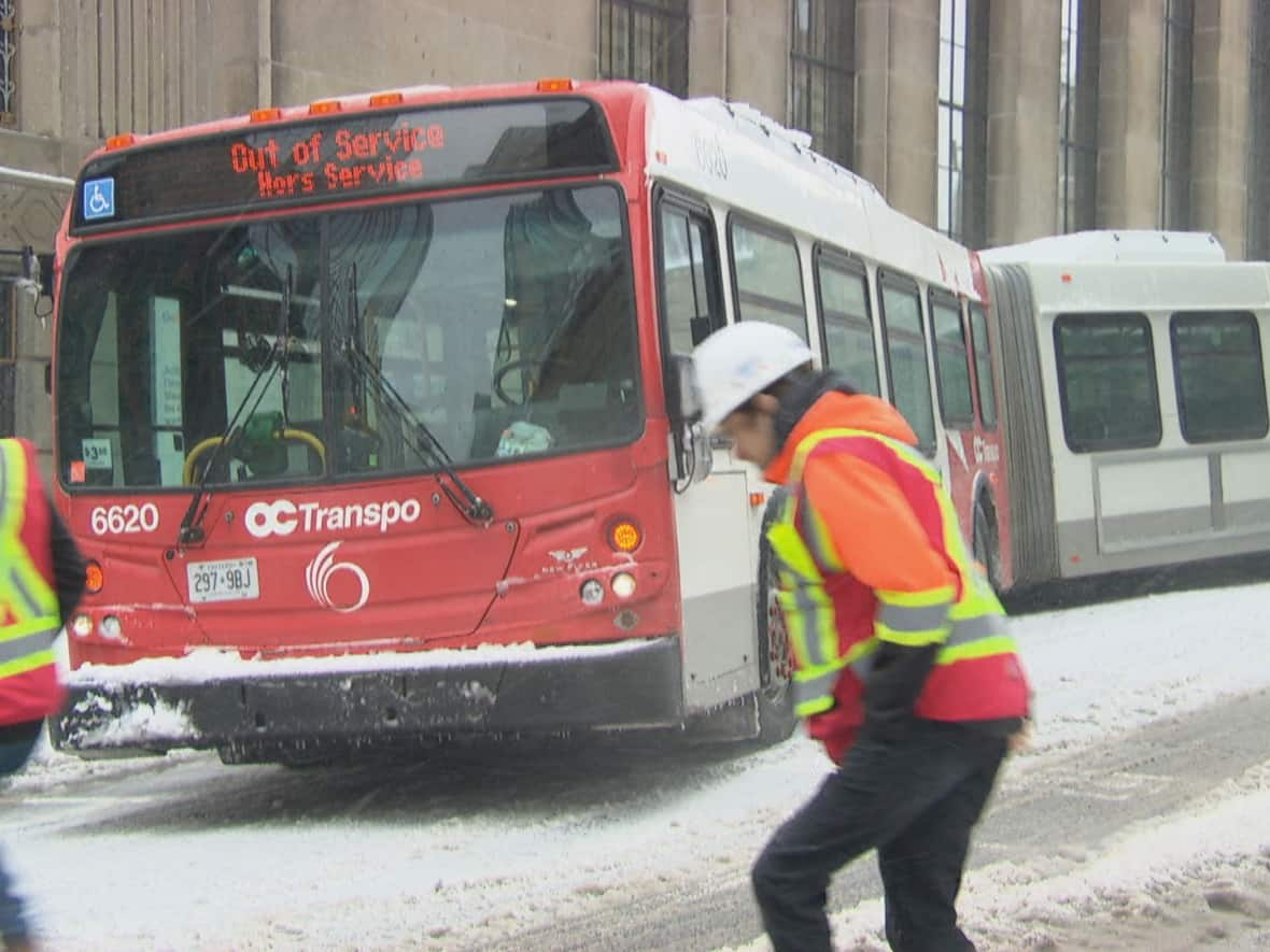 An articulated OC Transpo bus stuck in the snow in downtown Ottawa on Feb. 27, 2020. In a pilot project this winter, most articulated buses will be taken out of service in severe weather no matter which day of the week the storm hits. (CBC - image credit)