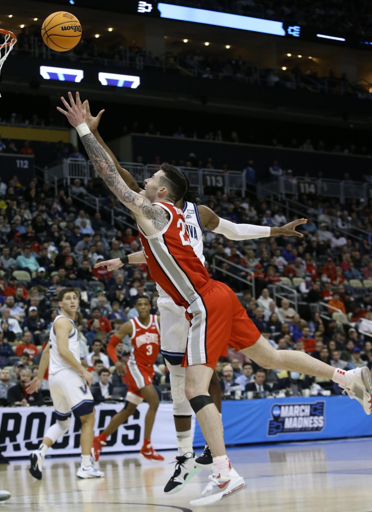 Mar 20, 2022; Pittsburgh, PA, USA; Ohio State Buckeyes forward Kyle Young (25) attempts to shoot the ball on Villanova Wildcats forward Eric Dixon (43) in the second half during the second round of the 2022 NCAA Tournament at PPG Paints Arena. Mandatory Credit: Charles LeClaire-USA TODAY Sports