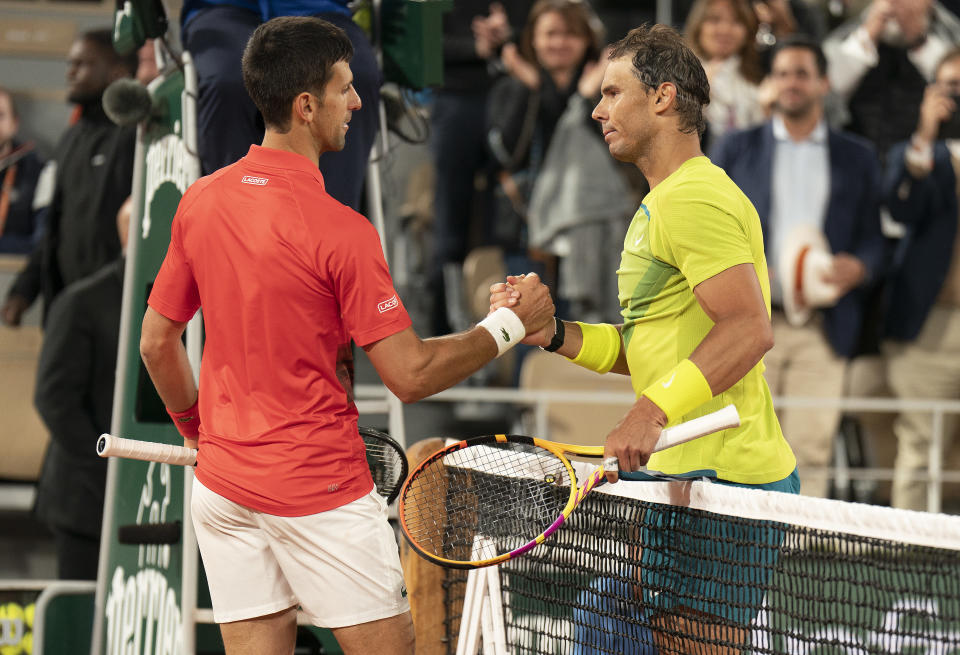 May 31, 2022; Paris, France; Rafael Nadal (ESP) at the net with Novak Djokovic (SRB) after their match on day 10 of the French Open at Stade Roland-Garros. Nadal won 6-2, 4-6, 6-2, 7-6 (4). Mandatory Credit: Susan Mullane-USA TODAY Sports