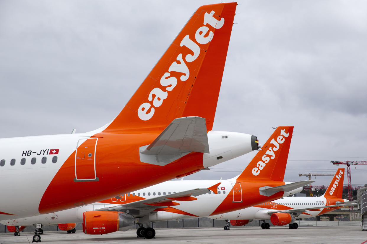 A large number of easyJet aircrafts are parked on the tarmac of the Geneve Aeroport, in Geneva, Switzerland, Monday, March 30, 2020. EasyJet, a British low-cost airline, on 30 March 2020 said it is ground its entire fleet of more than 300 planes amid ongoing Coronavirus COVID-19 crisis. The new coronavirus causes mild or moderate symptoms for most people, but for some, especially older adults and people with existing health problems, it can cause more severe illness or death. (Salvatore Di Nolfi/Keystone via AP)