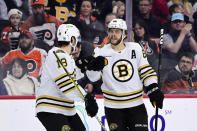 Boston Bruins' David Pastrnak, right, celebrates his goal with Pavel Zacha (18) during the first period of an NHL hockey game against the Philadelphia Flyers, Saturday, Jan. 27, 2024, in Philadelphia. (AP Photo/Derik Hamilton)