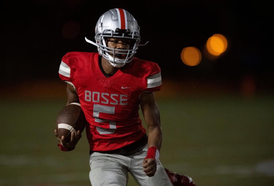 Bosse’s Elijah Wagner (5) carries the ball as the Bosse Bulldogs play the Harrison Warriors at Enlow Field in Evansville, Ind., Friday, Oct. 13, 2023.