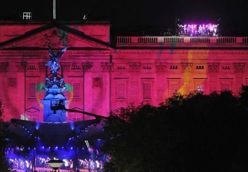 Buckingham Palace is illuminated as British band 'Madness' (Top R) perform on the roof of the Palace at the Diamond Jubilee Concert in London